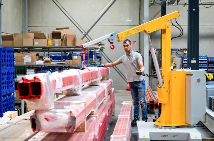Just Lift counterbalanced mini cranes lifting heavy equipment indoors