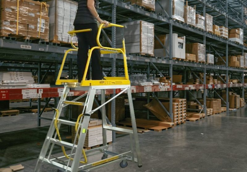 Warehouse worker using Stockmaster Navigator for safe order picking – fall prevention in Australian workplaces.