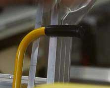 Navigator Mobile Warehouse Ladder positioned in an industrial setting, providing a secure elevated platform for warehouse staff.