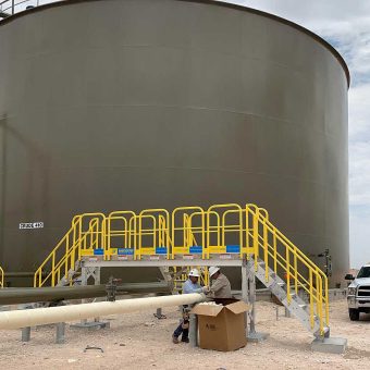 Maintenance team using an ErectaStep Stair System to safely access a below-grade diesel containment berm.