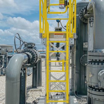 Powder-coated YellowGate Adjustable Safety Swing Gate in a factory